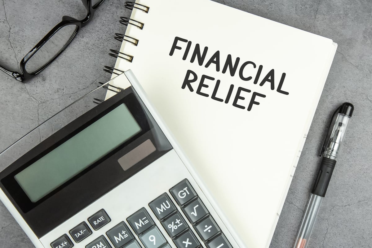 Financial Relief text on note pad with calculator